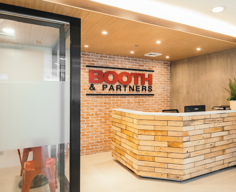 A reception area with a sign that says booth & partners.